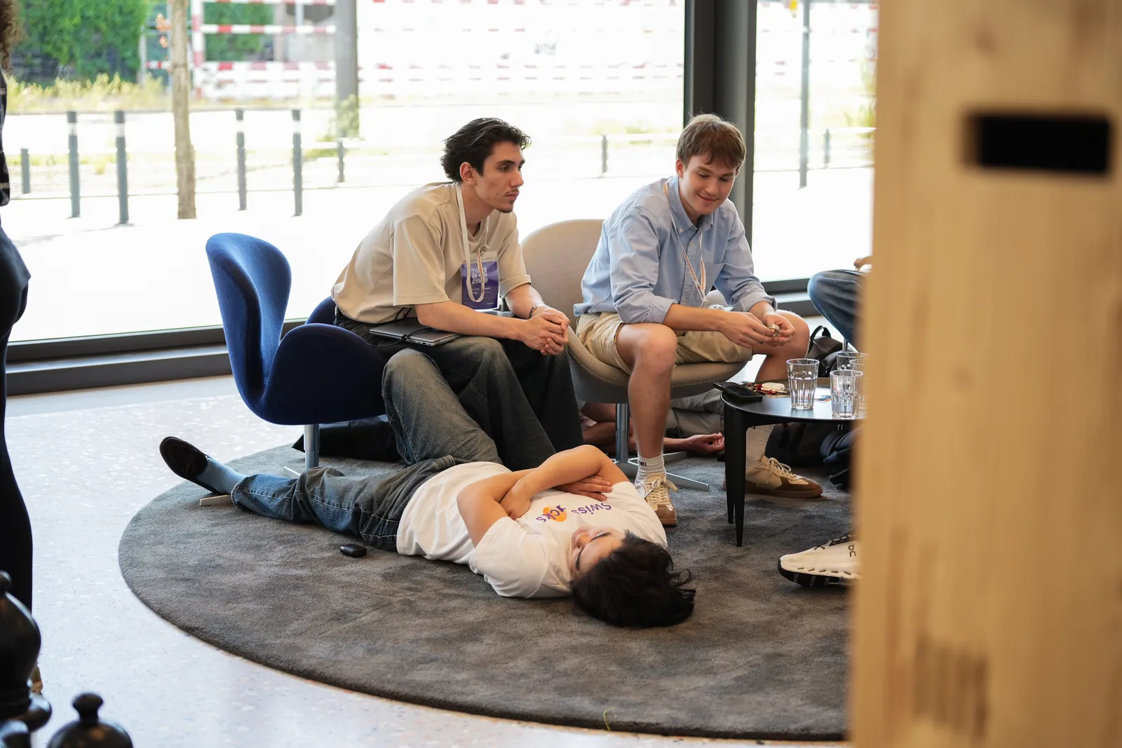 A hackathon teammate asleep on the floor of the venue mid-build